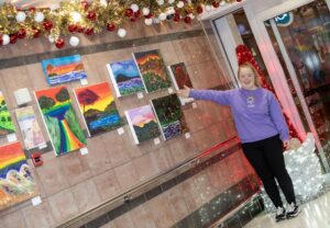 Tori pointing at artwork